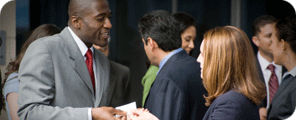 Image of exhibitors exchanging business cards.